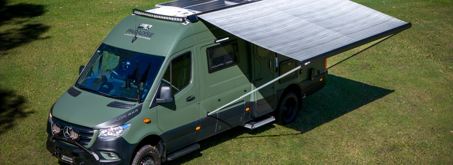 Paradise Oasis motorhome with awning out on the grass